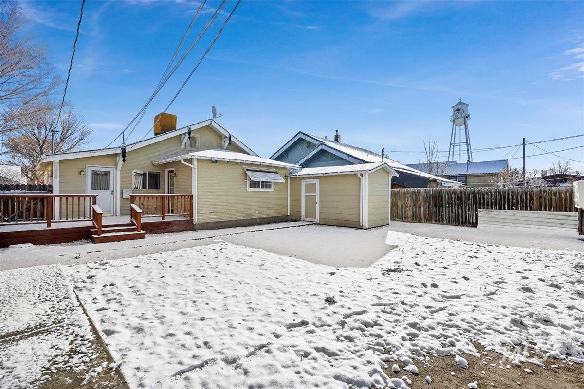 717 E Street Rupert, ID 83350 - Photo 22 of 24 Snow covered house with a deck and a chimney