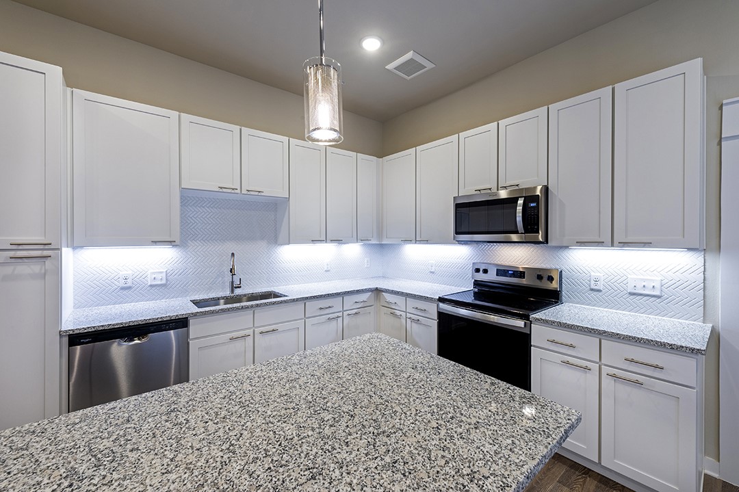1724 Partnership Way, Unit 3103 Katy, TX 77449 - Photo 23 of 34 a kitchen with a sink a stove and cabinets