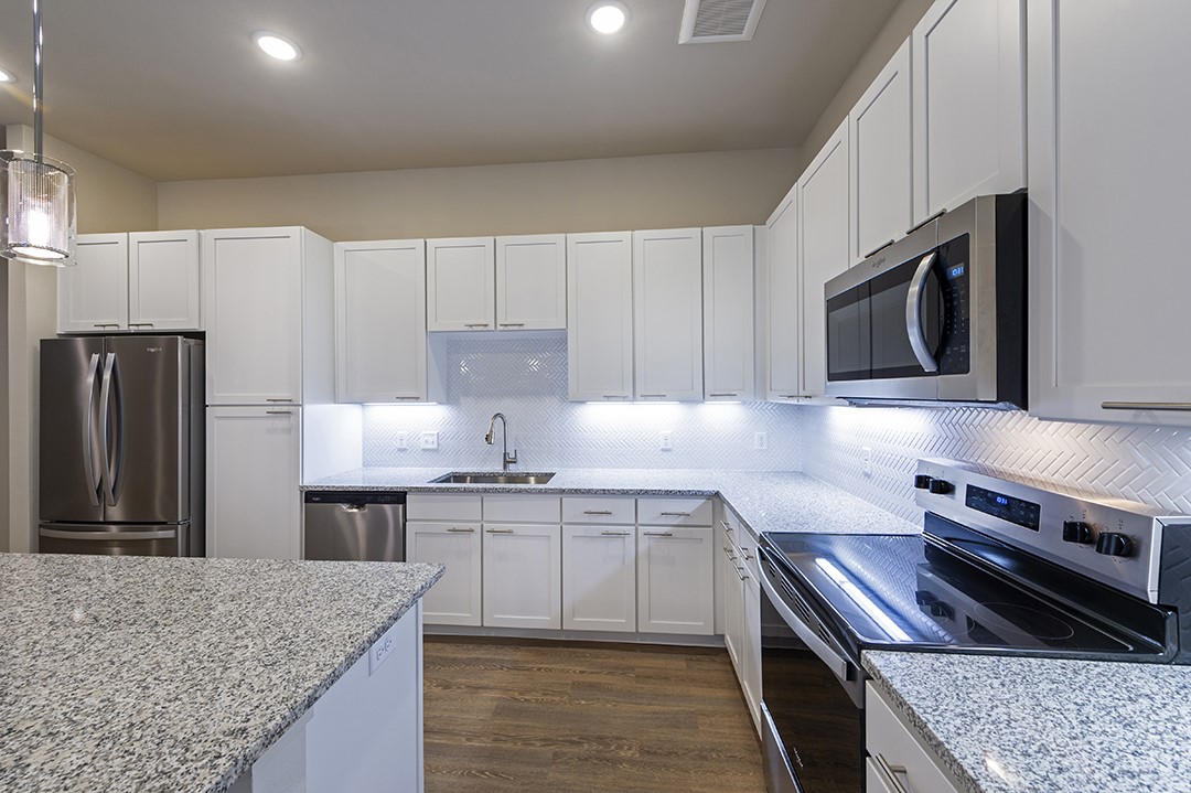1724 Partnership Way, Unit 3103 Katy, TX 77449 - Photo 24 of 34 a kitchen with stainless steel appliances granite countertop a sink stove and refrigerator