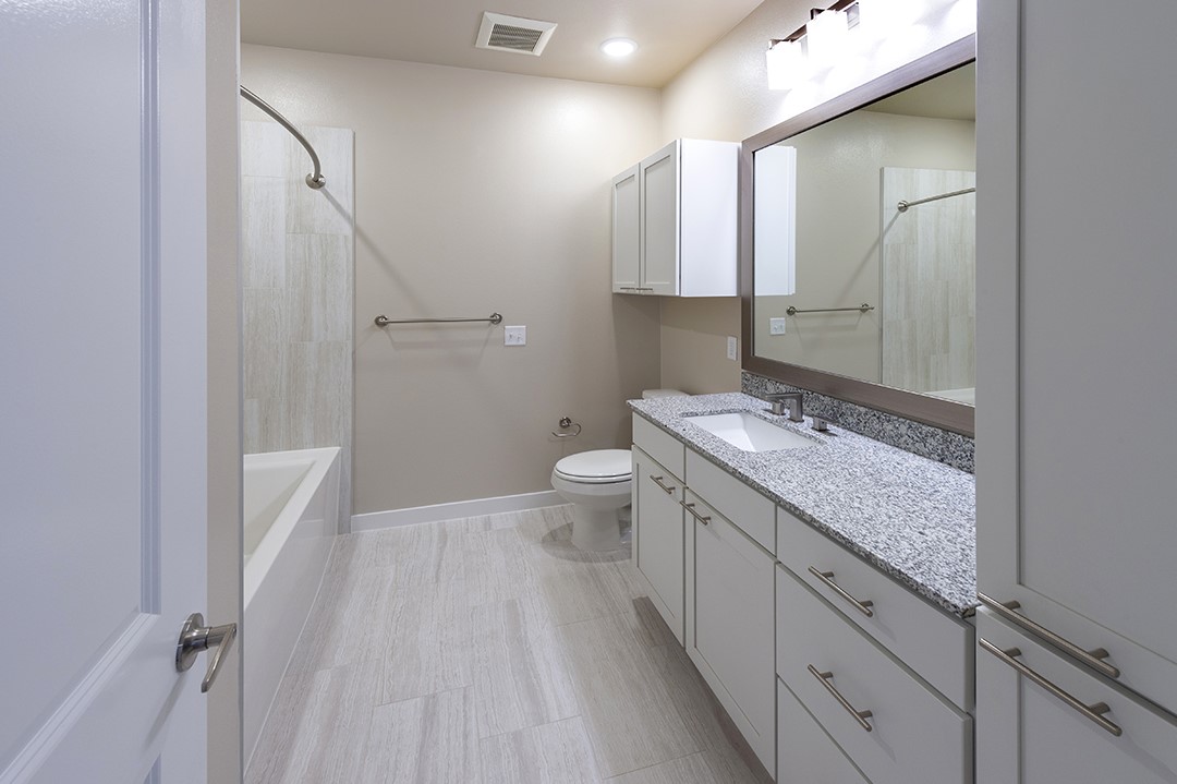 1724 Partnership Way, Unit 3103 Katy, TX 77449 - Photo 28 of 34 a spacious bathroom with a granite countertop sink toilet and mirror