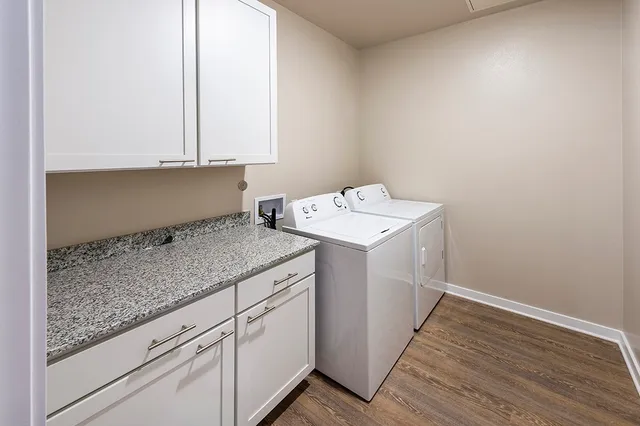 a utility room with a sink washer and dryer