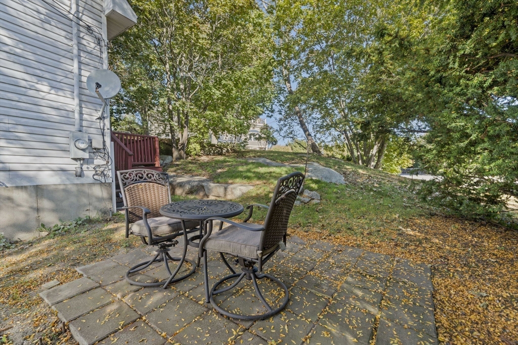 7 Babson Street Gloucester, MA 01930 - Photo 16 of 22 a patio with table and chairs and potted plants
