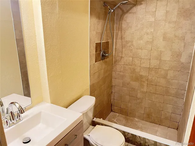 a bathroom with a sink toilet and shower