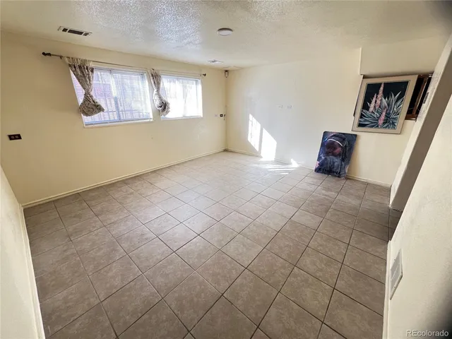 a view of empty room with window and hardwood floor