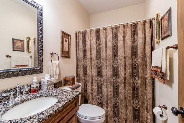 701 South 5000W Road Kankakee, IL 60901 - Photo 22 of 53 a bathroom with a granite countertop toilet sink and mirror
