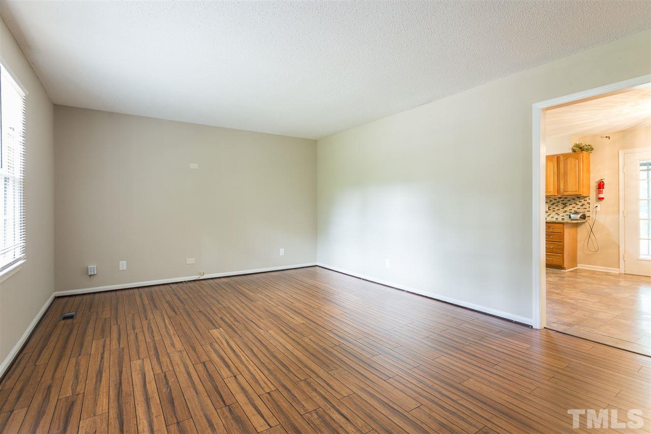 5508 Wettaw Lane Raleigh, NC 27616 - Photo 11 of 30 an empty room with wooden floor and windows