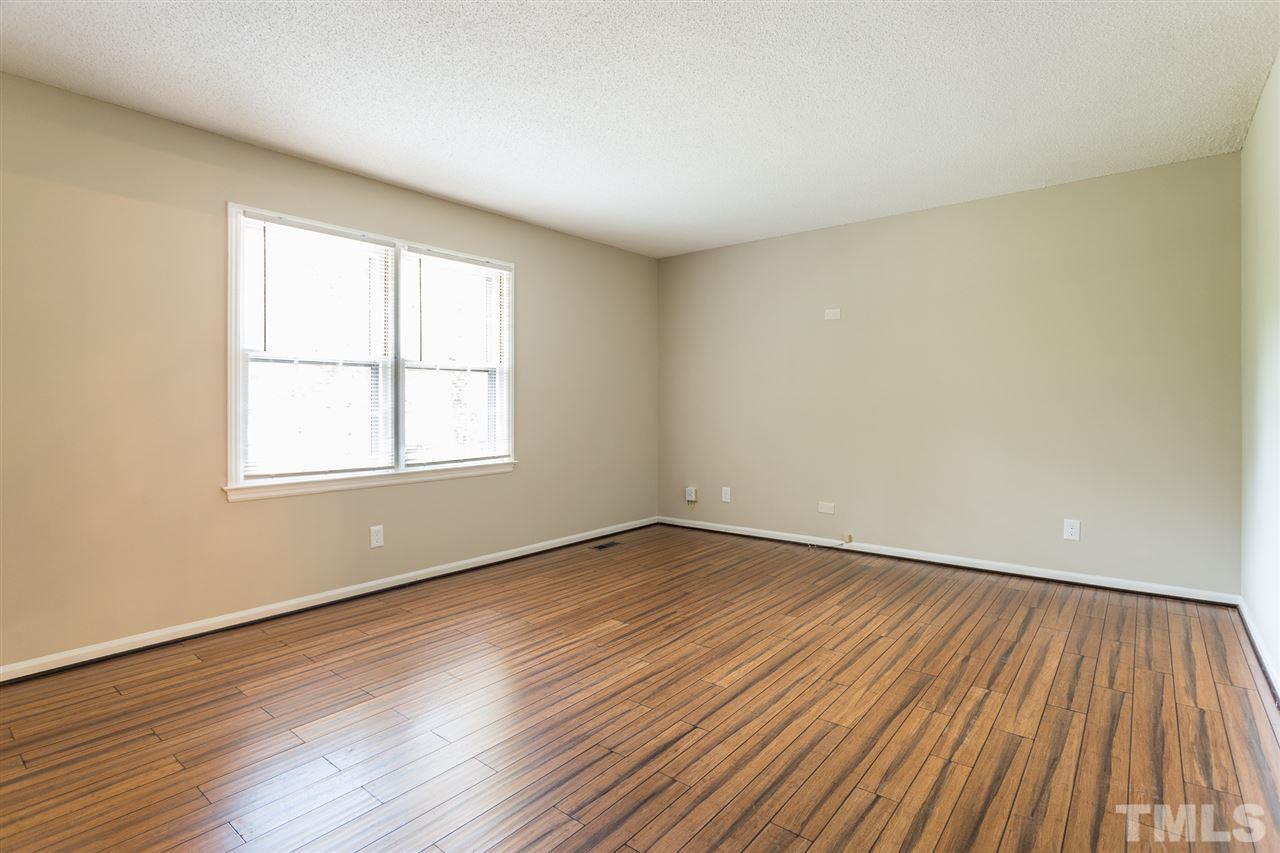 5508 Wettaw Lane Raleigh, NC 27616 - Photo 12 of 30 a view of an empty room with wooden floor and a window