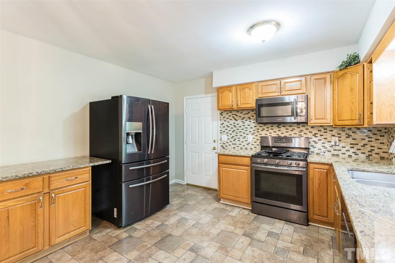 5508 Wettaw Lane Raleigh, NC 27616 - Photo 14 of 30 a kitchen with stainless steel appliances granite countertop a refrigerator stove and sink
