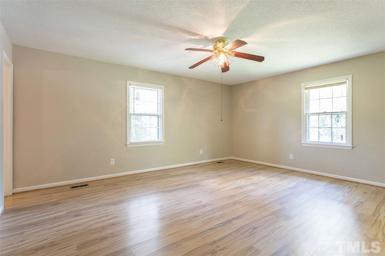 5508 Wettaw Lane Raleigh, NC 27616 - Photo 17 of 30 a view of an empty room with wooden floor and a window