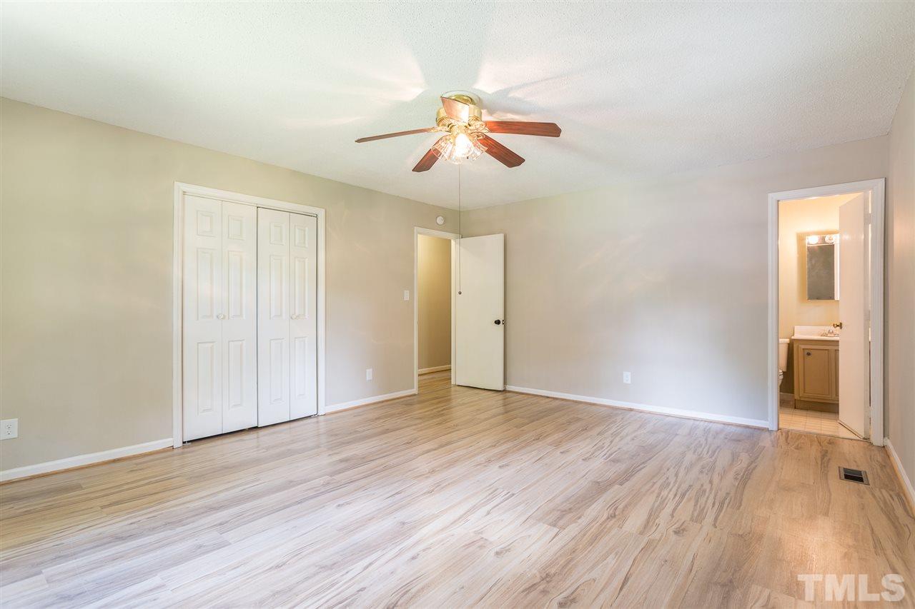 5508 Wettaw Lane Raleigh, NC 27616 - Photo 18 of 30 an empty room with wooden floor chandelier fan and closet area