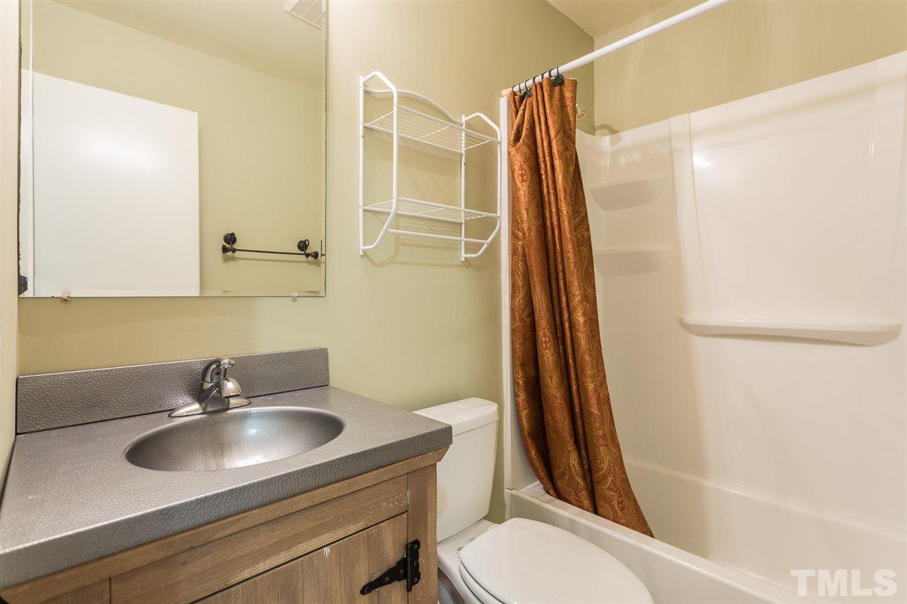 5508 Wettaw Lane Raleigh, NC 27616 - Photo 20 of 30 a bathroom with a sink toilet a mirror and shower