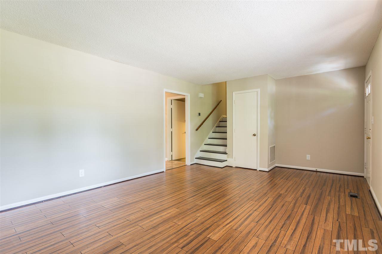 5508 Wettaw Lane Raleigh, NC 27616 - Photo 10 of 30 an empty room with wooden floor and stairs