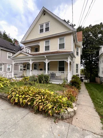 a front view of a house with a garden