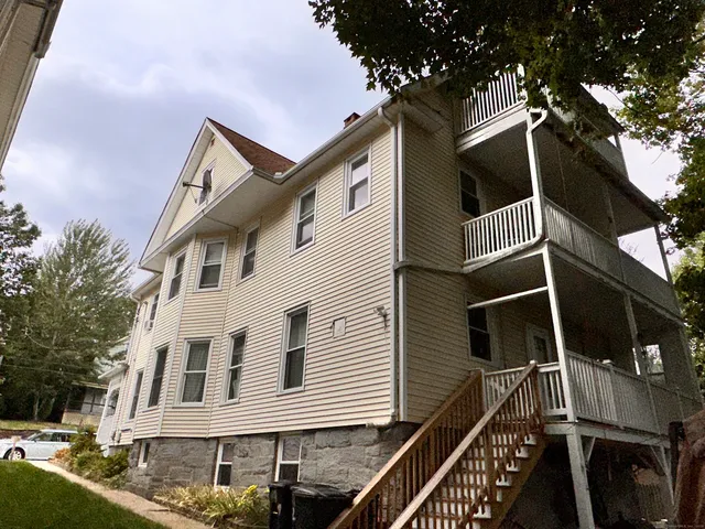 a view of a house with wooden fence