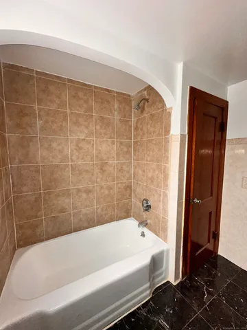 a bathroom with a bathtub and shower