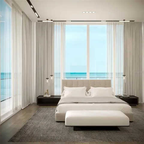 a living room with a flat screen tv and a rug