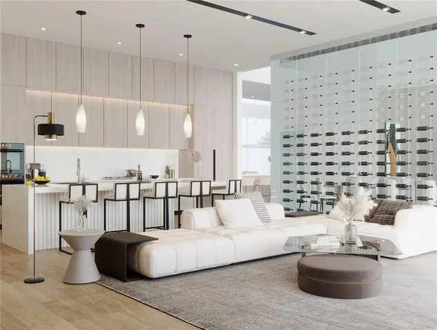 a living room with kitchen island furniture and a chandelier
