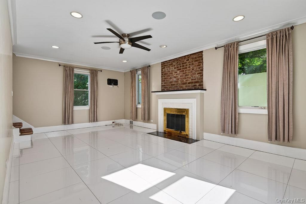 155 White Road Scarsdale, NY 10583 - Photo 13 of 30 a view of an empty room with a fireplace and a window