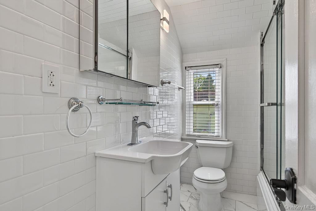 155 White Road Scarsdale, NY 10583 - Photo 16 of 30 a bathroom with a granite countertop sink toilet a mirror and shower