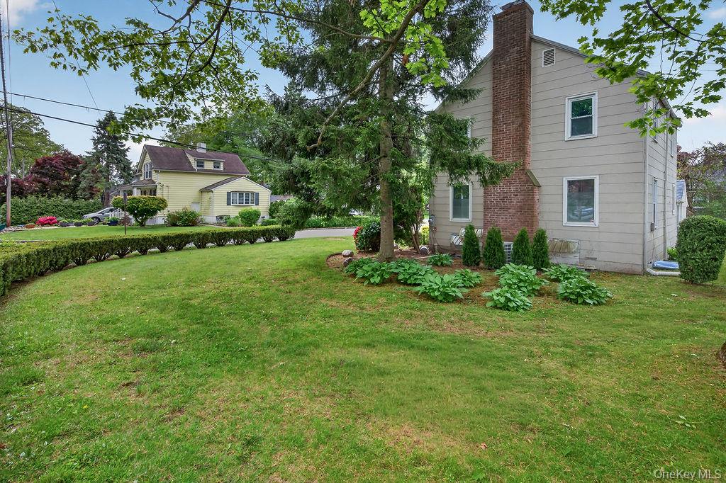 155 White Road Scarsdale, NY 10583 - Photo 26 of 30 a front view of a house with garden