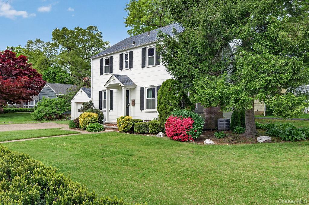 155 White Road Scarsdale, NY 10583 - Photo 27 of 30 a front view of a house with a garden and plants