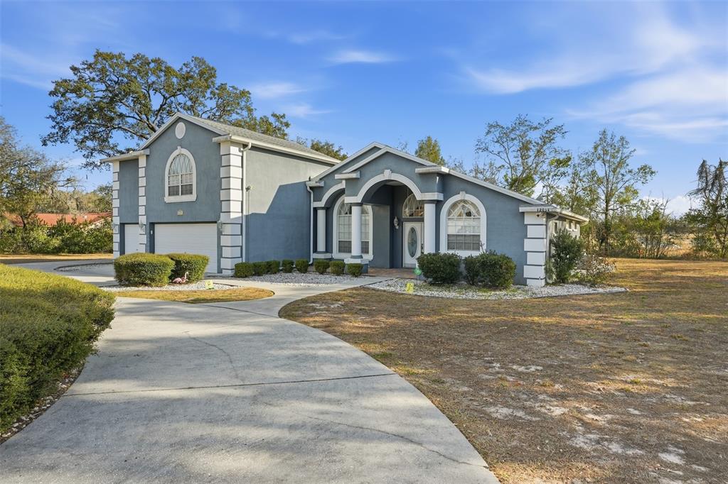 a front view of a house with a yard and garage