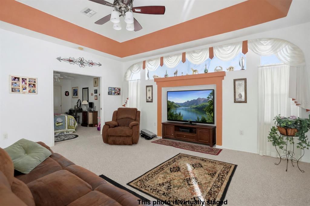 12054 Conway Street Spring Hill, FL 34609 - Photo 14 of 49 a living room with furniture and a flat screen tv