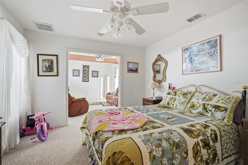 12054 Conway Street Spring Hill, FL 34609 - Photo 16 of 49 a bedroom with bed and window