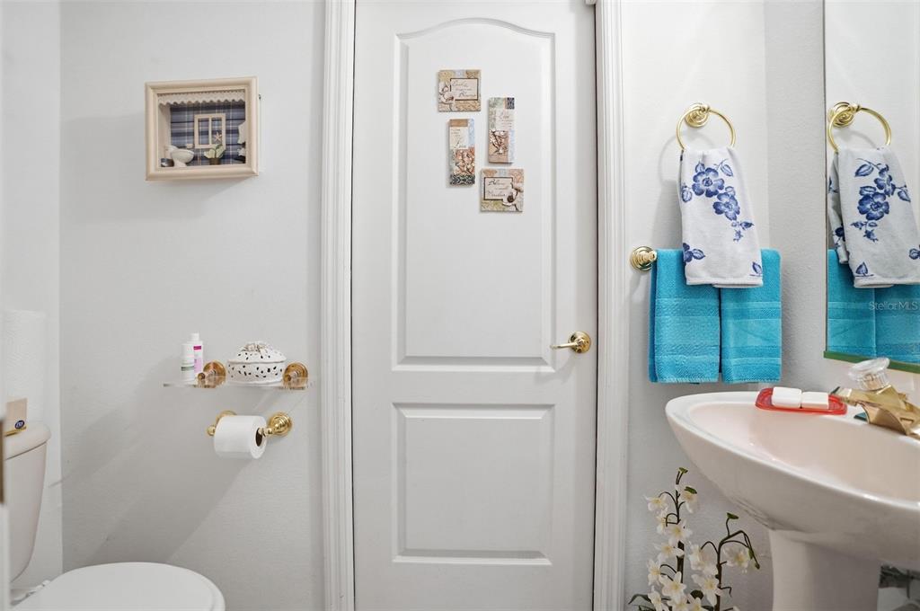 12054 Conway Street Spring Hill, FL 34609 - Photo 17 of 49 a bathroom with a sink mirror and toilet