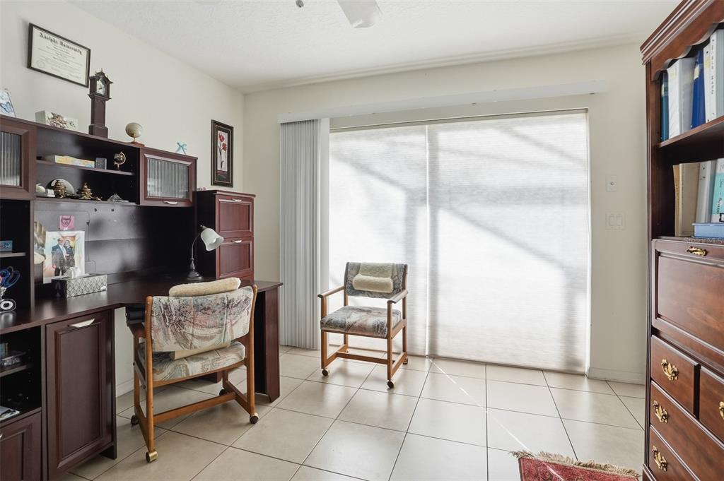 12054 Conway Street Spring Hill, FL 34609 - Photo 20 of 49 a kitchen with a table chairs and a refrigerator