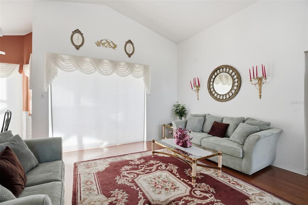 12054 Conway Street Spring Hill, FL 34609 - Photo 3 of 49 a living room with furniture and a wooden floor