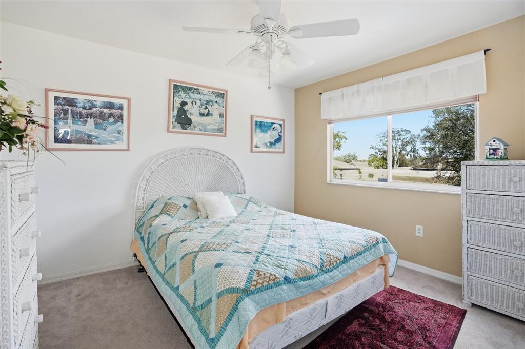 12054 Conway Street Spring Hill, FL 34609 - Photo 31 of 49 a bedroom with a bed and a window