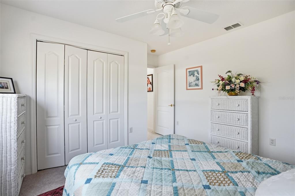 12054 Conway Street Spring Hill, FL 34609 - Photo 32 of 49 a bedroom with a bed and a dresser