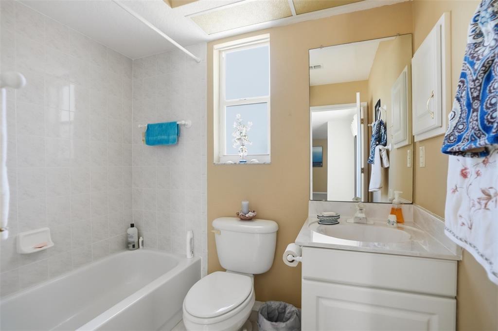 12054 Conway Street Spring Hill, FL 34609 - Photo 33 of 49 a bathroom with a toilet sink and mirror