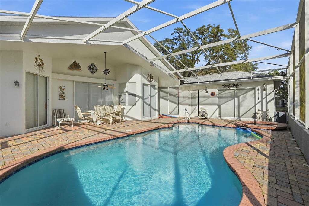 12054 Conway Street Spring Hill, FL 34609 - Photo 38 of 49 a view of a backyard with a table and chairs