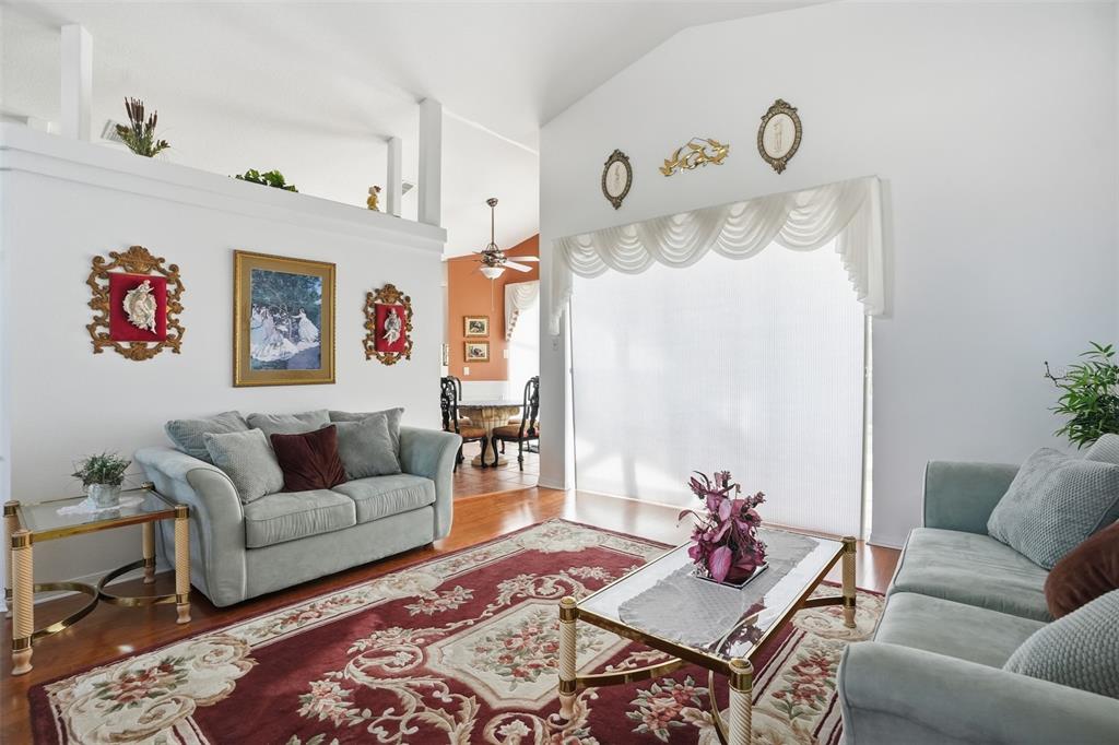 12054 Conway Street Spring Hill, FL 34609 - Photo 4 of 49 a living room with furniture wooden floor and a table