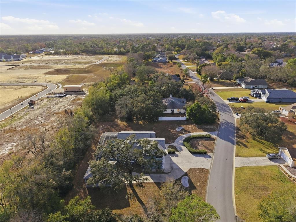 12054 Conway Street Spring Hill, FL 34609 - Photo 44 of 49 an aerial view of residential houses with outdoor space