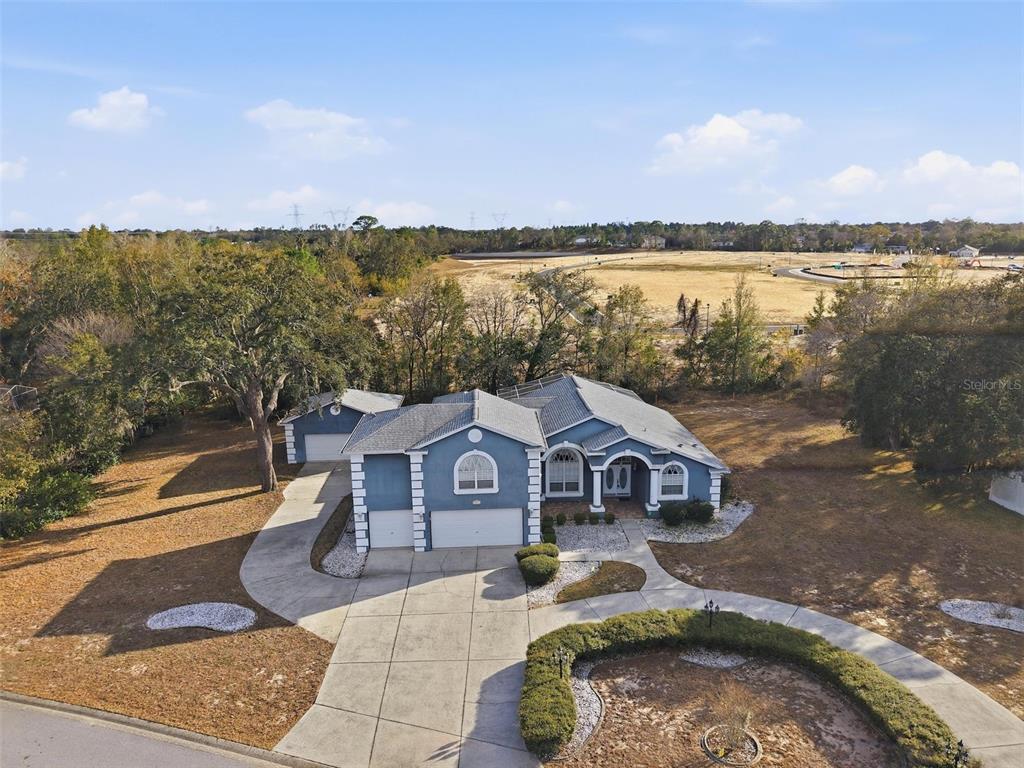 12054 Conway Street Spring Hill, FL 34609 - Photo 47 of 49 a front view of a house with a yard and balcony