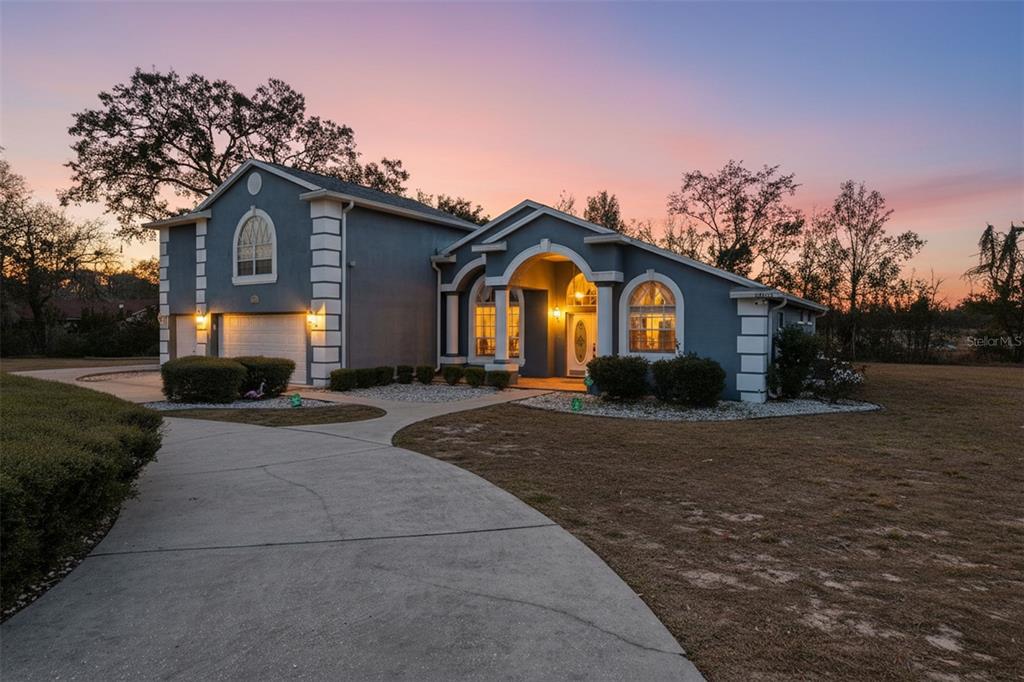 12054 Conway Street Spring Hill, FL 34609 - Photo 49 of 49 a front view of a house with a yard and garage