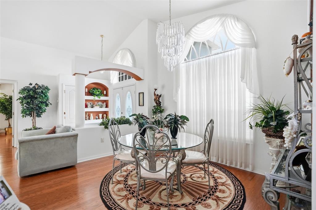 12054 Conway Street Spring Hill, FL 34609 - Photo 6 of 49 a living room with furniture and a chandelier
