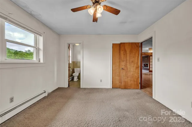 an empty room with windows and closet