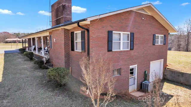 a front view of a house with yard and parking space