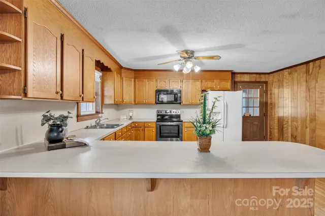 a kitchen with a refrigerator a stove top oven a sink and dishwasher