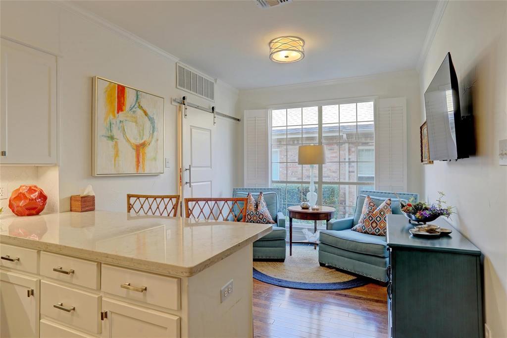 1229 Wooded Trail Hurst, TX 76053 - Photo 12 of 28 dining room open to kitchen and breakfast bar with barn door to utility room.