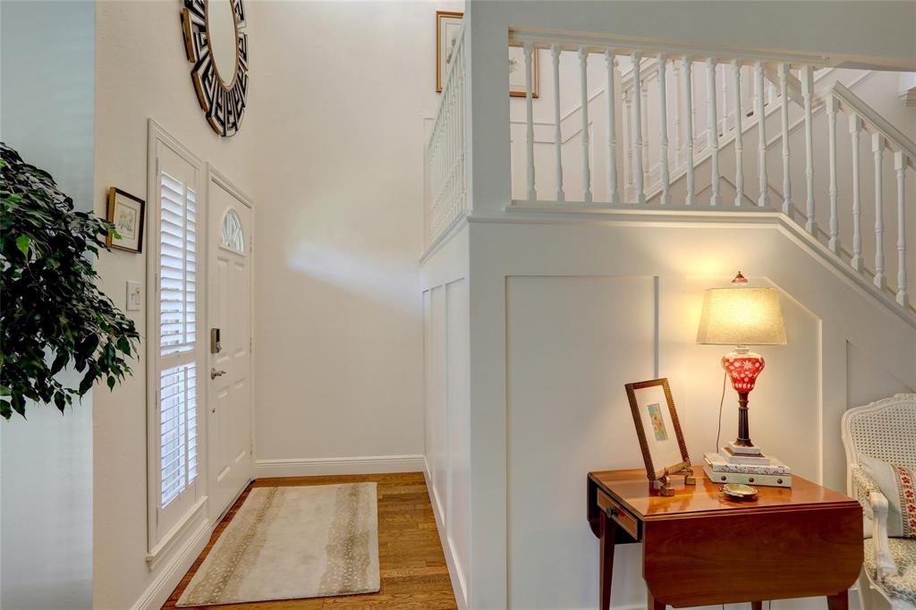1229 Wooded Trail Hurst, TX 76053 - Photo 16 of 28 Entrance foyer featuring stairway, wood finished floors, and a high ceiling