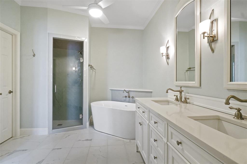 1229 Wooded Trail Hurst, TX 76053 - Photo 21 of 28 Full bath featuring a freestanding tub, double vanity, a shower stall, light marble finish flooring, and crown molding