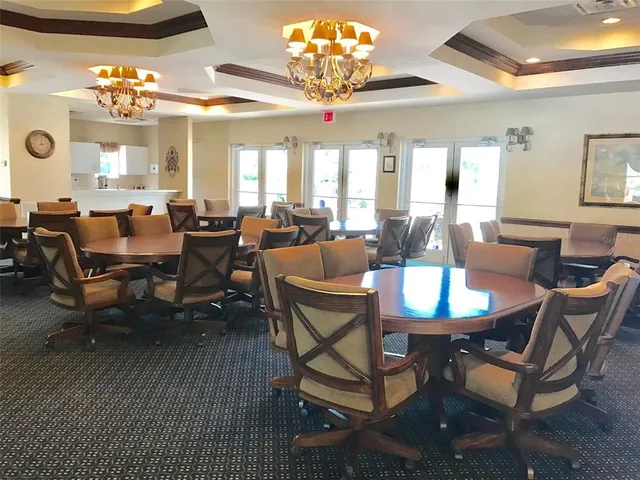 a view of a dining room with furniture and chandelier