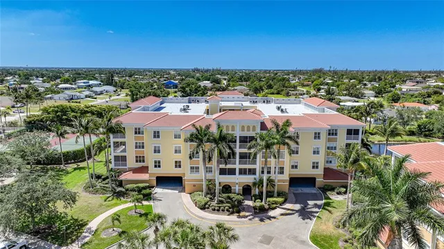 an aerial view of a house with a garden and lake view