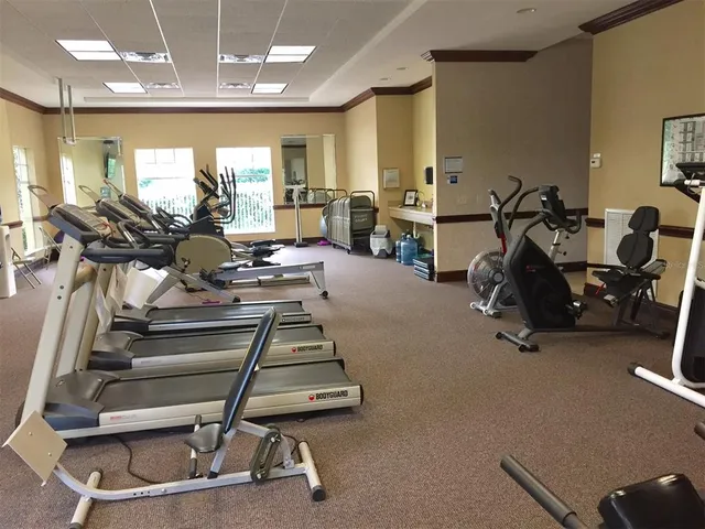 a room with gym equipment and a large window
