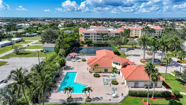 an aerial view of residential houses with outdoor space and trees